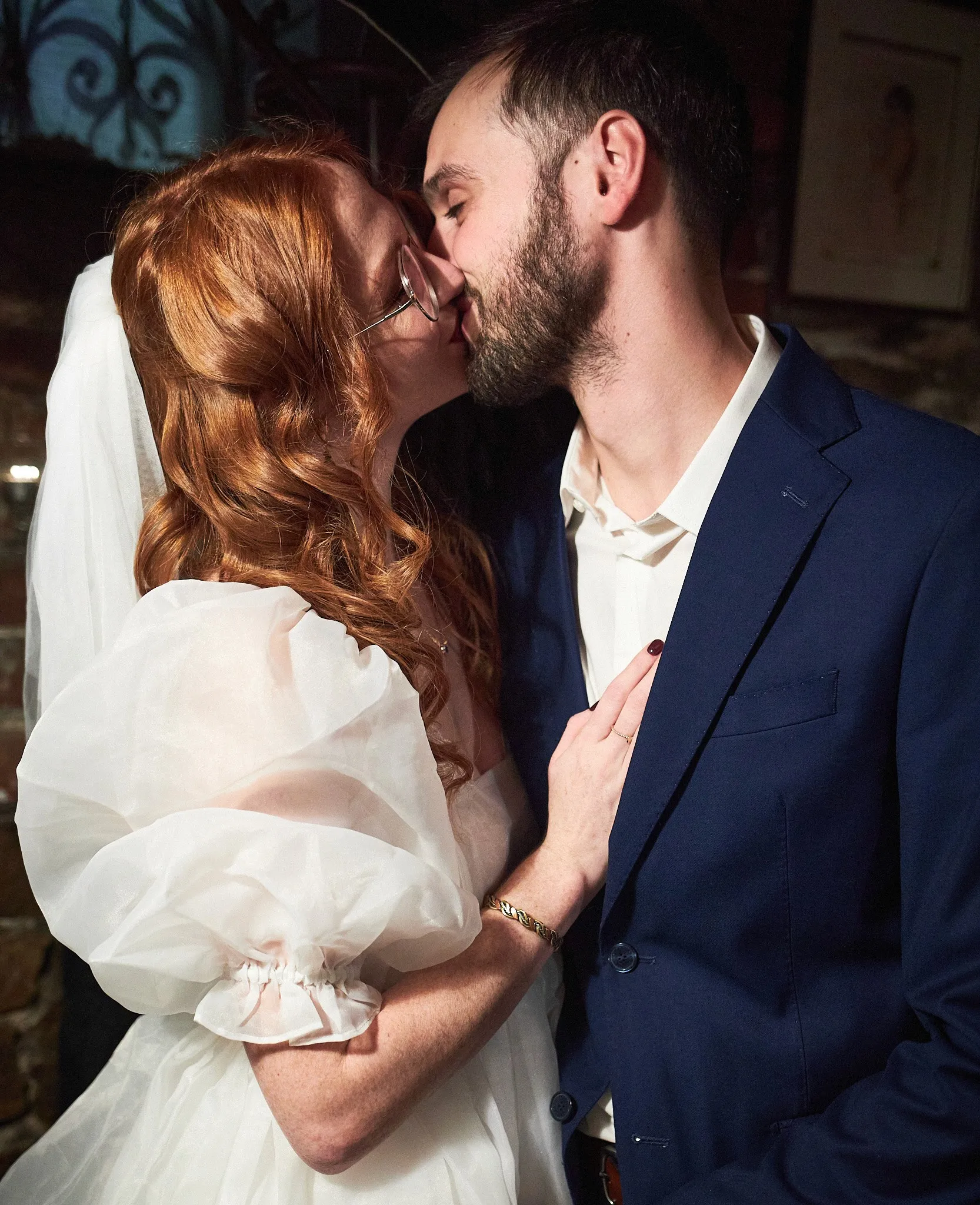 Red-haired bride kissing the groom